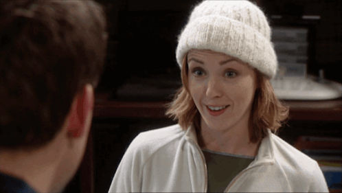 Woman In White Beanie And Jacket Smiling At Man GIF