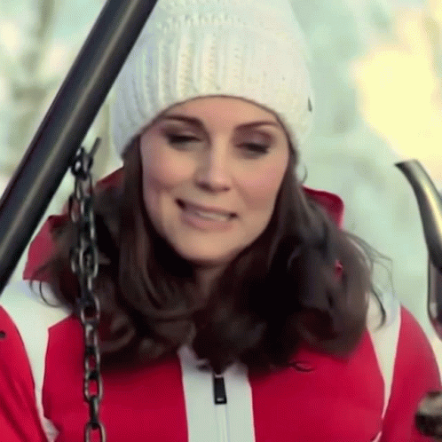 A Woman Wearing A White Hat And A Red Jacket GIF