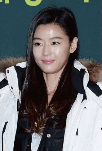 A Woman Wearing A White Jacket With The Letter A On The Collar GIF