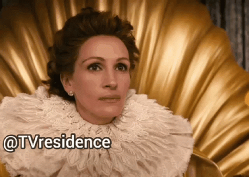 A Woman Wearing A White Lace Collar Is Sitting On A Gold Chair With The Words Tvresidence Written Below Her GIF