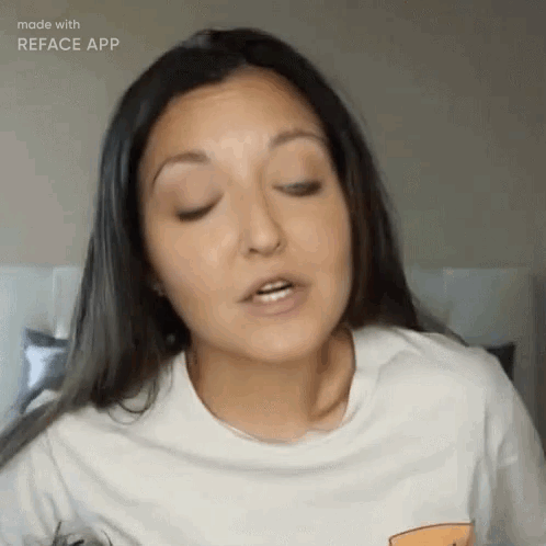 A Woman Wearing A White T-Shirt Is Making A Funny Face . GIF