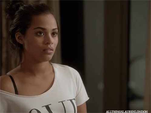 A Woman Wearing A White T-Shirt That Says " All Things Lauren London " GIF