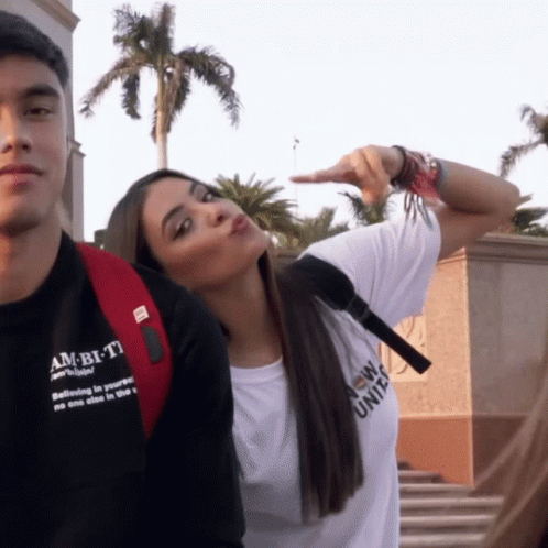 A Woman Wearing A White T-Shirt That Says Ambitio On It GIF