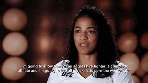 A Woman Wearing A White Ufc Shirt Says I 'M Going To Show That I Am An Aggressive Fighter GIF