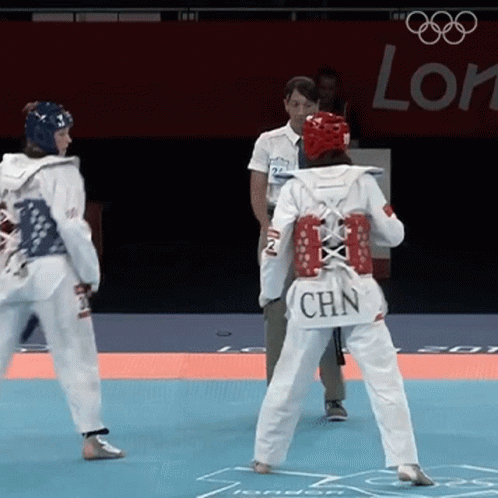 A Woman Wearing A White Uniform With Chn On The Back GIF