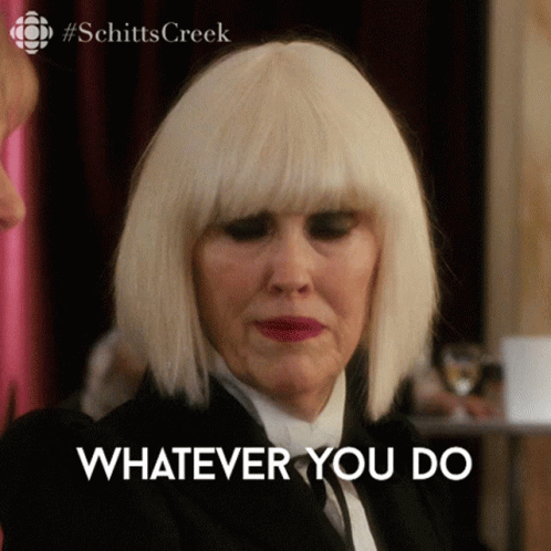 A Woman Wearing A Wig And A Suit Says " Whatever You Do " GIF
