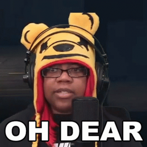 A Woman Wearing A Winnie The Pooh Hat And Headphones Is Speaking Into A Microphone . GIF