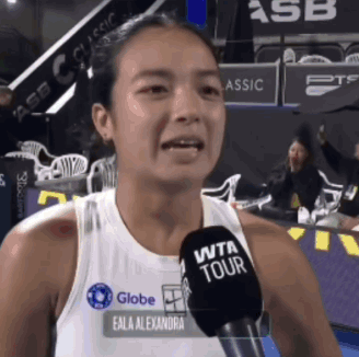 A Woman Wearing A Wta Tour Tank Top Is Talking Into A Microphone GIF