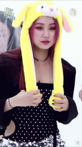 A Woman Wearing A Yellow Hat With Bunny Ears And The Words Prop Room Dance On The Bottom GIF