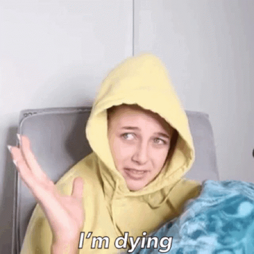 A Woman Wearing A Yellow Hoodie Is Saying I 'M Dying GIF