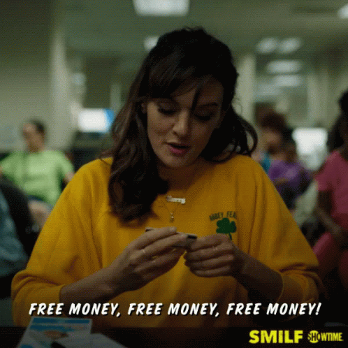 A Woman Wearing A Yellow Shirt That Says Barley Tea Is Sitting At A Table GIF