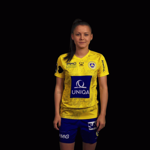 A Woman Wearing A Yellow Shirt With The Word Uniqa On The Front GIF