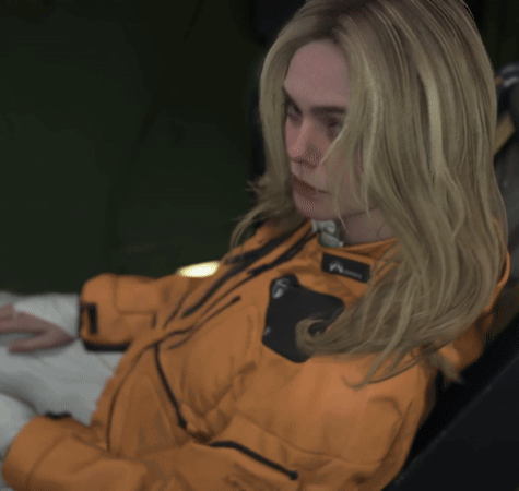 A Woman Wearing An Orange Jacket That Says Level 7 GIF