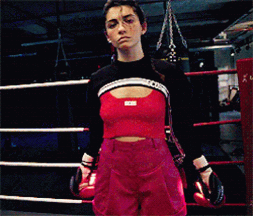 A Woman Wearing Boxing Gloves And A Crop Top That Says Bcci GIF