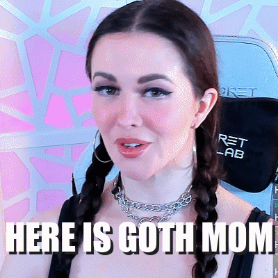 A Woman Wearing Braids And A Necklace With The Words Here Is Goth Mom Written Below Her GIF