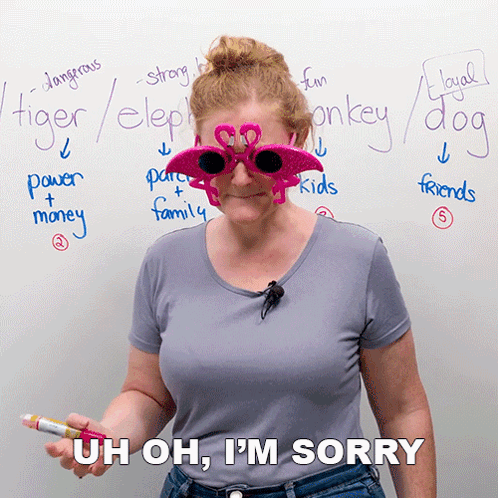 A Woman Wearing Flamingo Sunglasses Is Standing In Front Of A Whiteboard With Words Like Tiger Elephant And Monkey Writt GIF