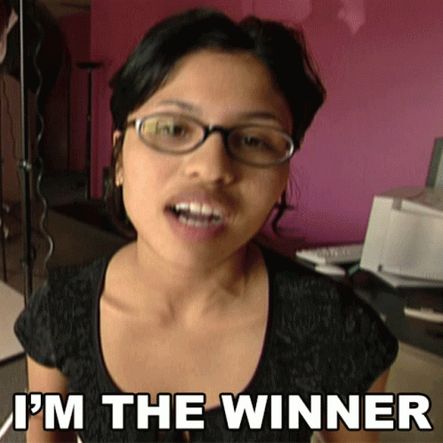 A Woman Wearing Glasses And A Black Shirt Says I 'M The Winner GIF