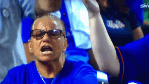 A Woman Wearing Glasses And A Blue Shirt With The Word Miami On It Looks Angry GIF