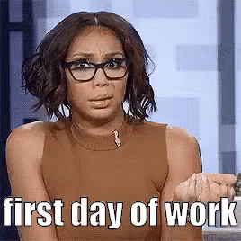 A Woman Wearing Glasses And A Brown Tank Top Is Sitting In Front Of A Window . GIF