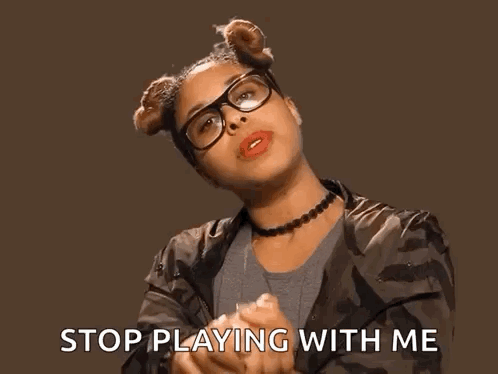 A Woman Wearing Glasses And A Choker Says Stop Playing With Me . GIF