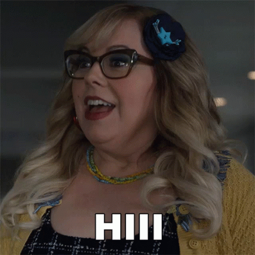 A Woman Wearing Glasses And A Flower In Her Hair Says Hill GIF