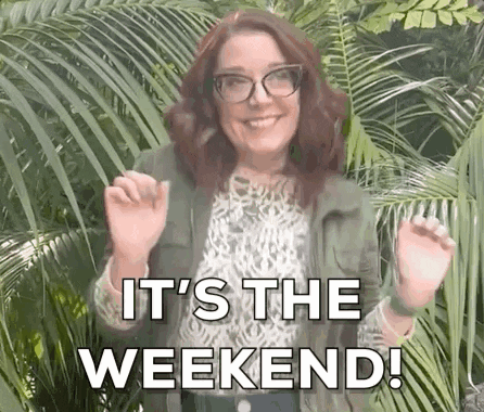 A Woman Wearing Glasses And A Green Jacket Is Standing In Front Of Palm Trees And Says `` It 'S The Weekend '' . GIF