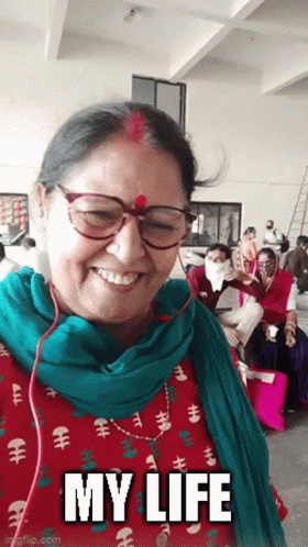 a woman wearing glasses and a green scarf is smiling with the words my life below her