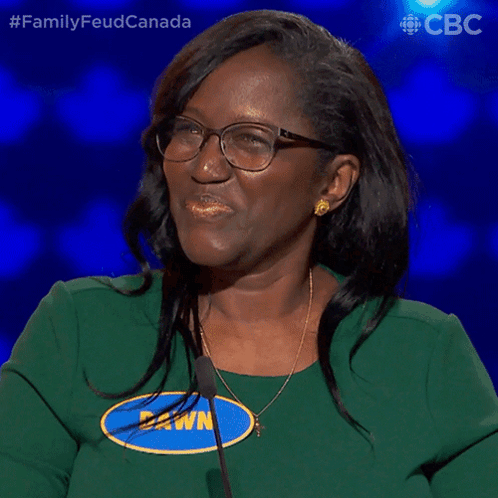 A Woman Wearing Glasses And A Green Shirt Says " Yes " GIF