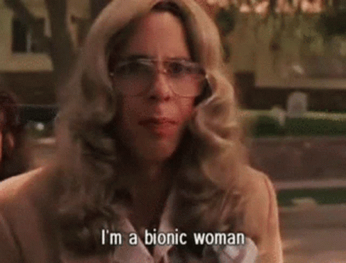 A Woman Wearing Glasses And A Jacket Is Talking About Herself . GIF
