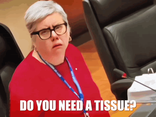 A Woman Wearing Glasses And A Lanyard With The Words Do You Need A Tissue GIF