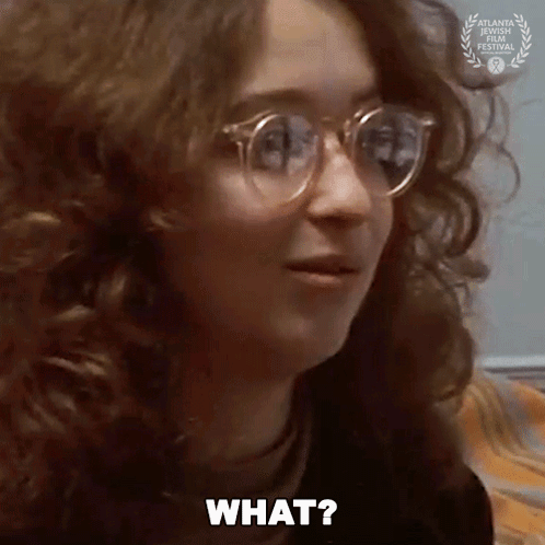 Woman With Glasses And Laurel Wreath Asking What GIF