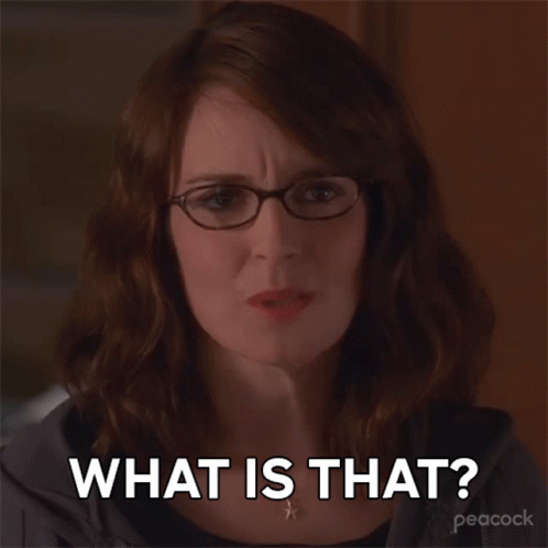 A Woman Wearing Glasses And A Necklace Says What Is That GIF