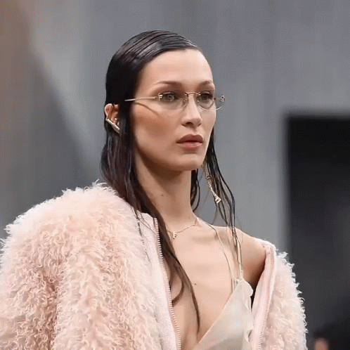 A Woman Wearing Glasses And A Pink Fur Coat GIF