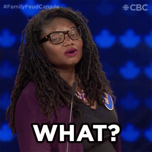A Woman Wearing Glasses And A Purple Jacket Says " What " GIF