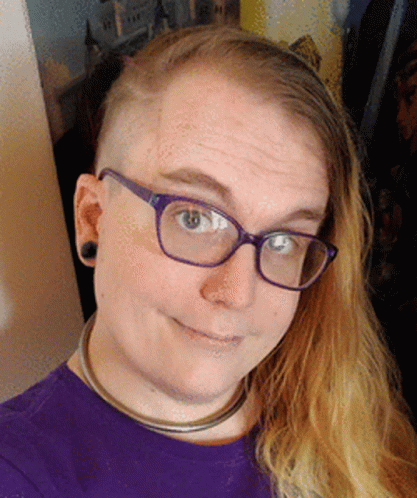 A Woman Wearing Glasses And A Purple Shirt GIF