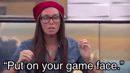 A Woman Wearing Glasses And A Red Hat Is Saying " Put On Your Game Face " . GIF