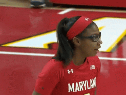 A Woman Wearing Glasses And A Red Maryland Shirt GIF