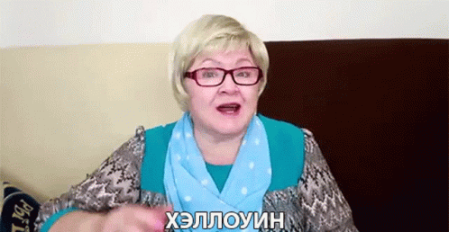 A Woman Wearing Glasses And A Scarf Is Talking In Russian GIF