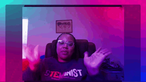 A Woman Wearing Glasses And A Shirt That Says Steminist GIF