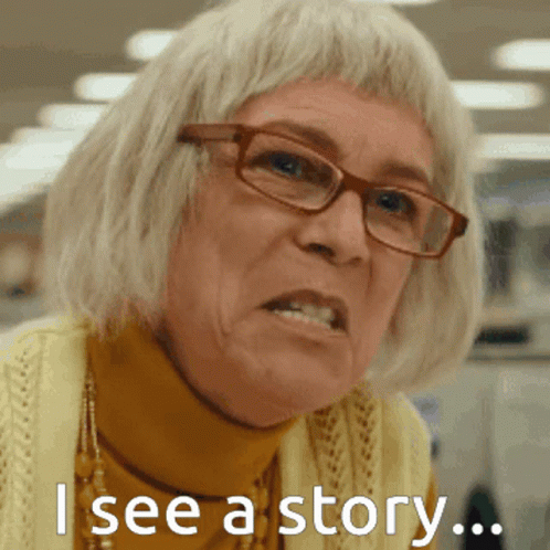 A Woman Wearing Glasses And A Yellow Sweater Has The Words " I See A Story " On Her Face GIF