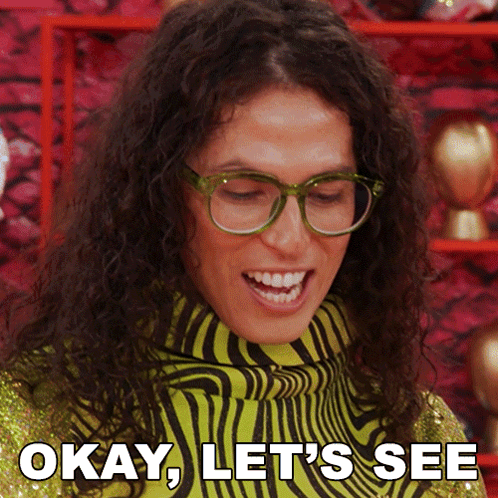 A Woman Wearing Glasses And A Zebra Print Sweater Says " Okay Let 'S See " GIF