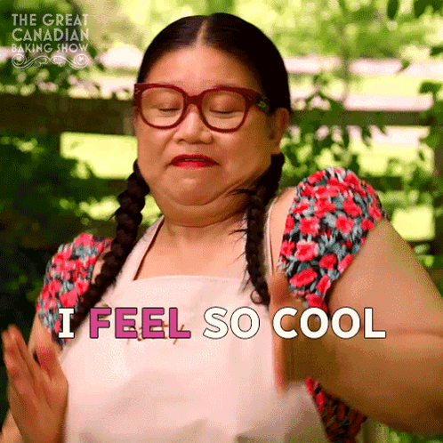 A Woman Wearing Glasses And An Apron Is Saying I Feel So Cool GIF