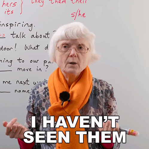 A Woman Wearing Glasses And An Orange Scarf Is Standing In Front Of A White Board And Says I Haven 'T Seen Them GIF