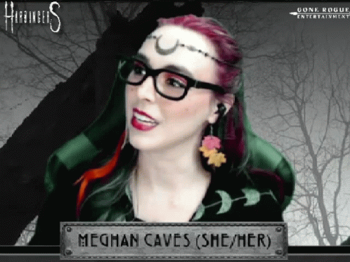 A Woman Wearing Glasses And Earrings Is Named Meghan Caves ( She / Her ) GIF