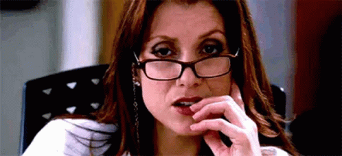 Woman Wearing Glasses And Earrings Sitting GIF