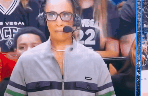 A Woman Wearing Glasses And Headphones With The Number 22 On Her Jersey GIF