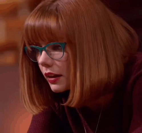 A Woman Wearing Glasses And Red Lipstick Says Le Gasp . GIF