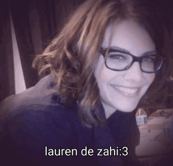 A Woman Wearing Glasses And Smiling With Lauren De Zahi : 3 Written Below Her GIF
