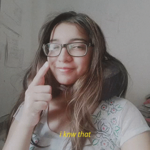 A Woman Wearing Glasses Giving A Thumbs Up With The Words I Know That Behind Her GIF