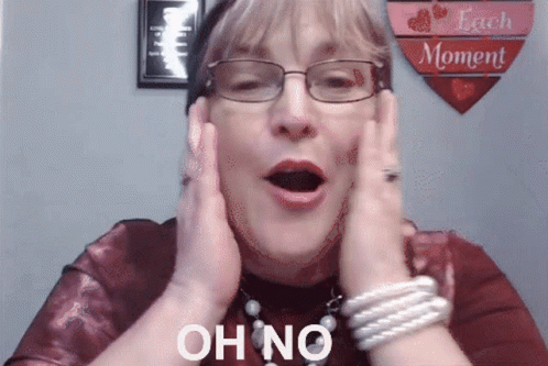 A Woman Wearing Glasses Holds Her Hands To Her Face And Says " Oh No " GIF